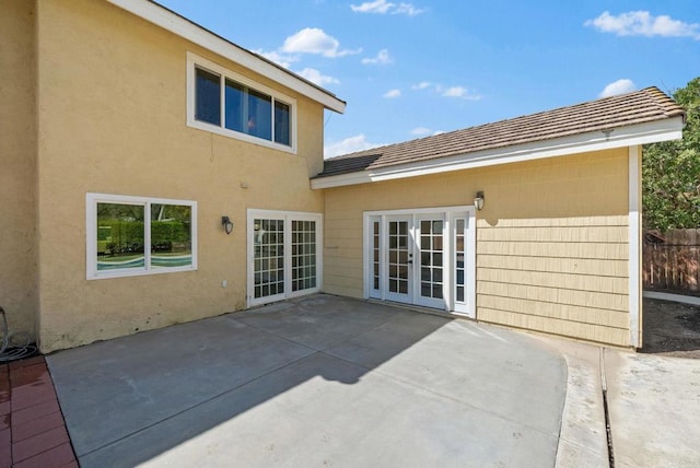 back of house with a patio, stucco siding, french doors, and fence