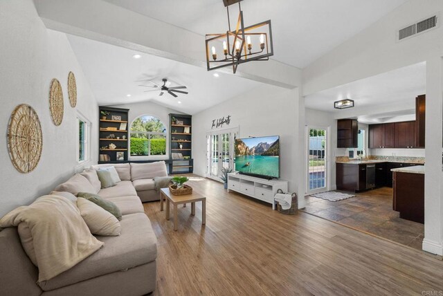 41910 Humber Dr, Temecula, CA 92591 - living area featuring vaulted ceiling, healthy amount of natural light, built in shelves, a chandelier, and dark wood-style flooring