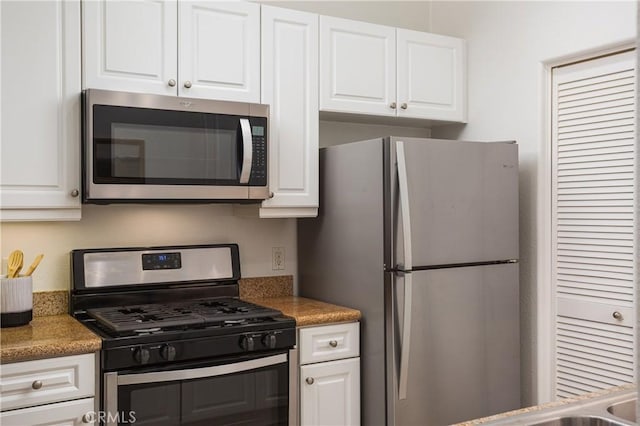 kitchen featuring white cabinets and appliances with stainless steel finishes