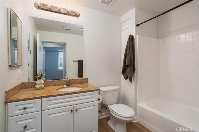 full bath with wood finished floors, toilet, shower / tub combination, vanity, and visible vents