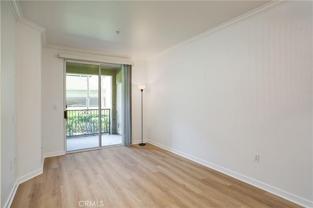 unfurnished room with ornamental molding, light wood finished floors, and baseboards