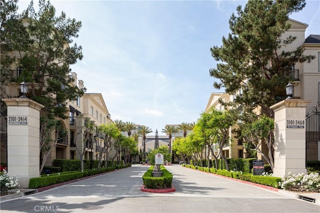 view of road with a residential view, curbs, and street lights