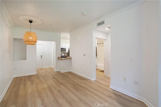 interior space featuring baseboards, visible vents, crown molding, and light wood-style flooring