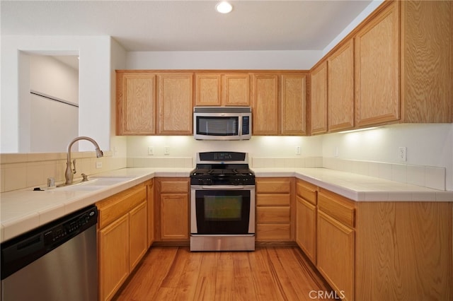 36337 Vincenzo Way, Winchester, CA 92596 - kitchen featuring stainless steel appliances, light wood-style flooring, tile countertops, and recessed lighting