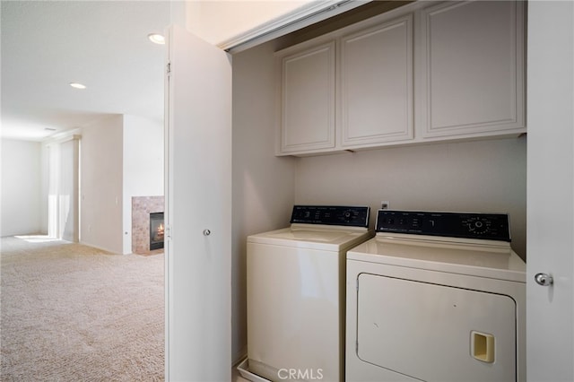 36337 Vincenzo Way, Winchester, CA 92596 - washroom featuring washer and clothes dryer, cabinet space, a premium fireplace, carpet flooring, and recessed lighting