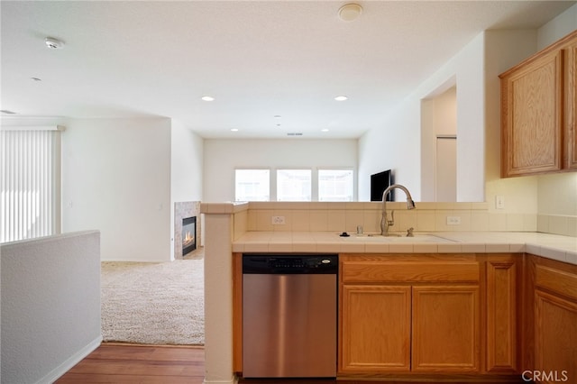 36337 Vincenzo Way, Winchester, CA 92596 - kitchen featuring stainless steel dishwasher, a glass covered fireplace, a peninsula, and open floor plan