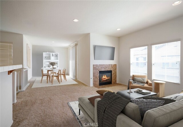 36337 Vincenzo Way, Winchester, CA 92596 - living room featuring a tile fireplace, light colored carpet, and recessed lighting