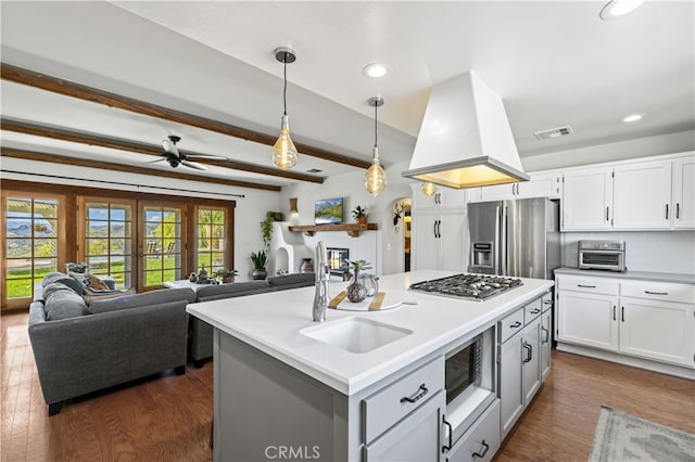 kitchen with stainless steel appliances, visible vents, white cabinets, and a sink