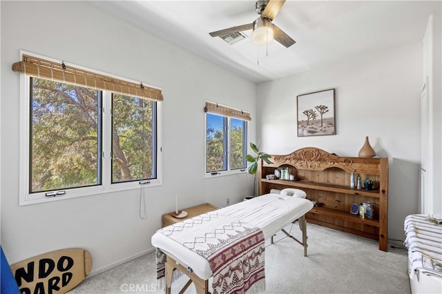 interior space featuring carpet, visible vents, and a ceiling fan