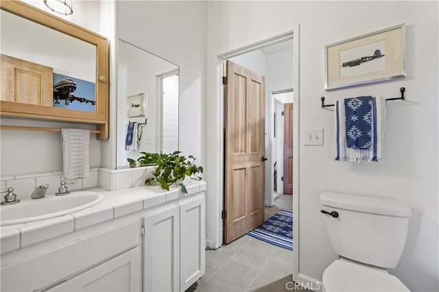 bathroom featuring tile patterned floors, toilet, and vanity