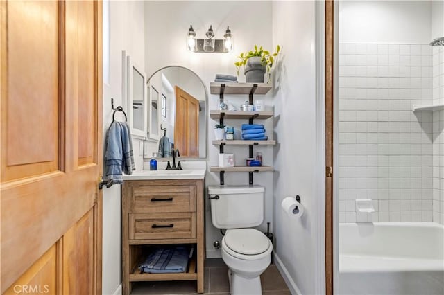 full bath featuring vanity, baseboards, tile patterned floors, toilet, and shower / bathtub combination