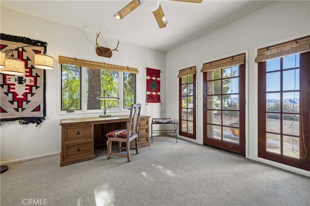 office area featuring baseboards, a ceiling fan, plenty of natural light, and carpet floors