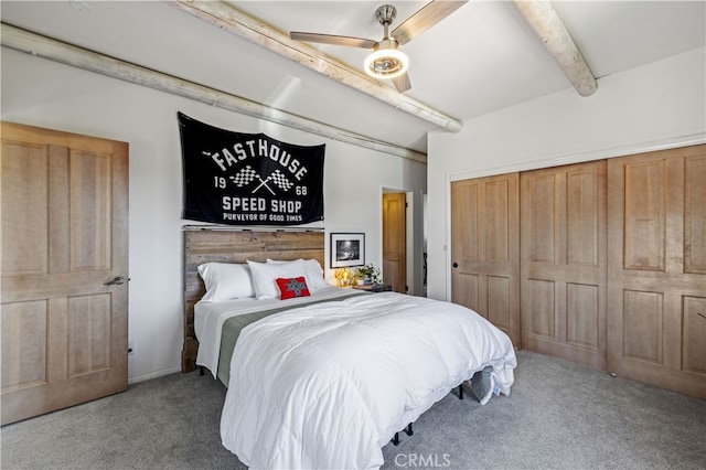 bedroom with a closet, a ceiling fan, carpet flooring, and beamed ceiling