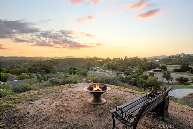 view of home's community featuring a mountain view and an outdoor fire pit