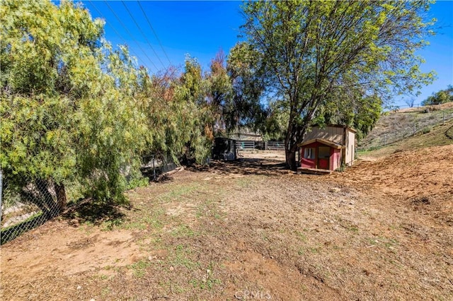 view of yard with an outdoor structure and fence