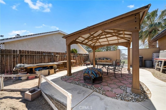 view of patio / terrace with a gazebo, outdoor dining area, and a fenced backyard
