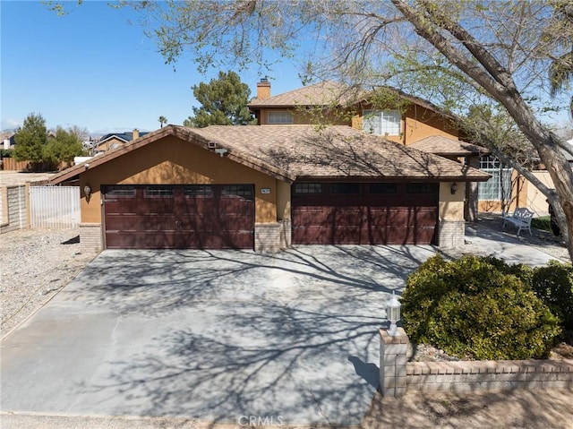 view of front of home featuring stucco siding, driveway, a chimney, and fence