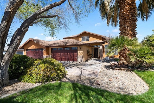 view of front facade with stucco siding, concrete driveway, and an attached garage