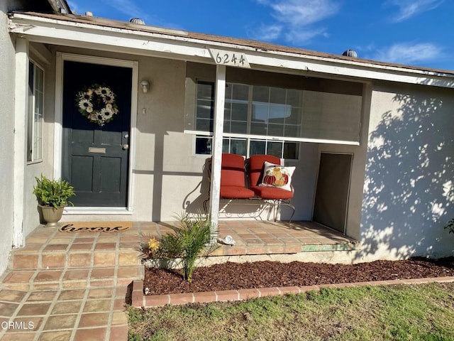 entrance to property featuring stucco siding