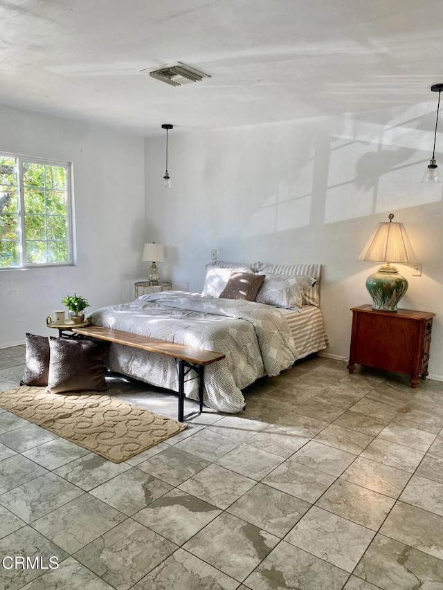 bedroom featuring baseboards and visible vents