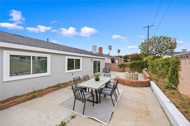 view of patio / terrace featuring central air condition unit, a fenced backyard, and outdoor dining space