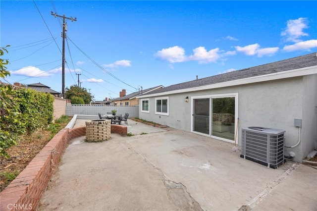 rear view of property featuring cooling unit, a fenced backyard, a patio, outdoor dining space, and stucco siding