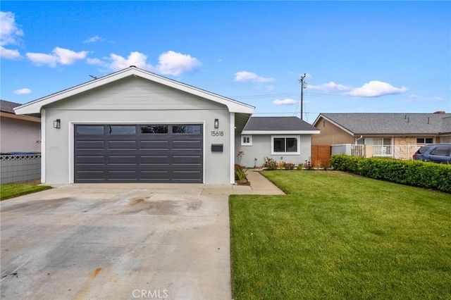 ranch-style home with a garage, fence, stucco siding, and a front yard