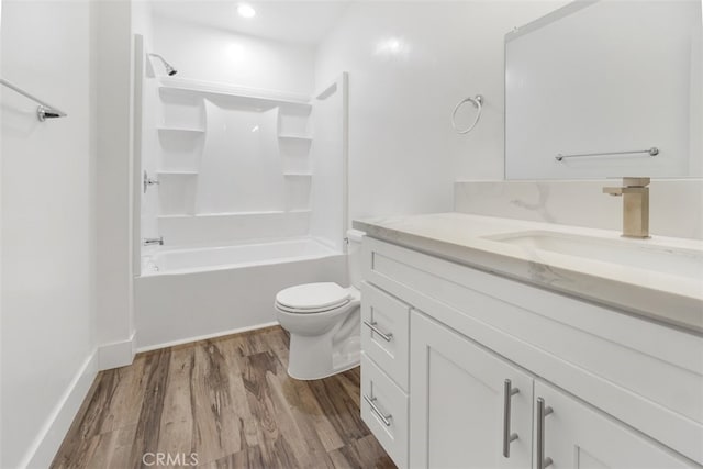 full bath with toilet, vanity,  shower combination, and wood finished floors