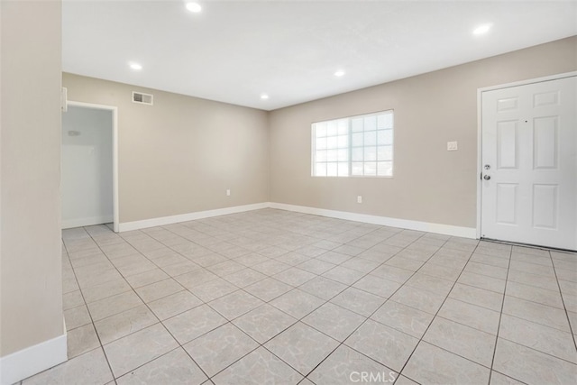 empty room featuring recessed lighting, visible vents, and baseboards
