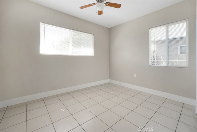 unfurnished room featuring baseboards and ceiling fan