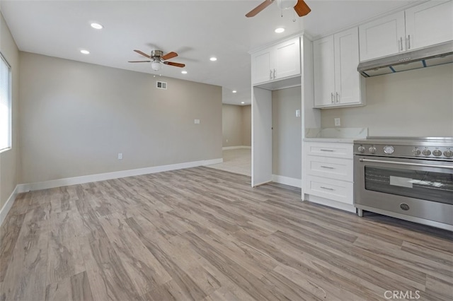kitchen with a ceiling fan, visible vents, under cabinet range hood, high end stainless steel range, and white cabinetry