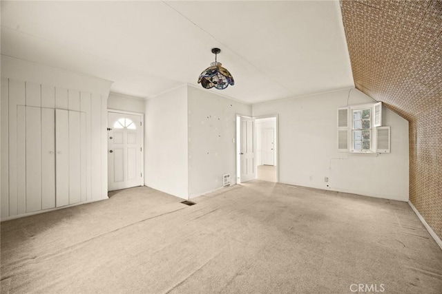 interior space featuring visible vents, carpet flooring, and vaulted ceiling