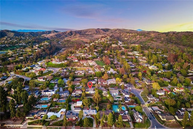 aerial view at dusk with a mountain view and a residential view