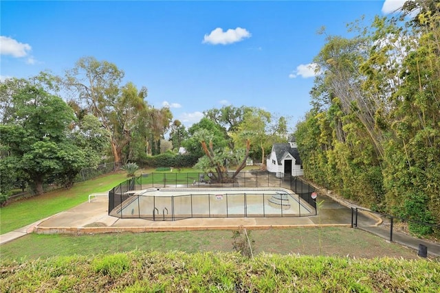 view of swimming pool featuring a yard, a fenced in pool, and fence