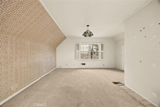 bonus room featuring vaulted ceiling, carpet, and visible vents