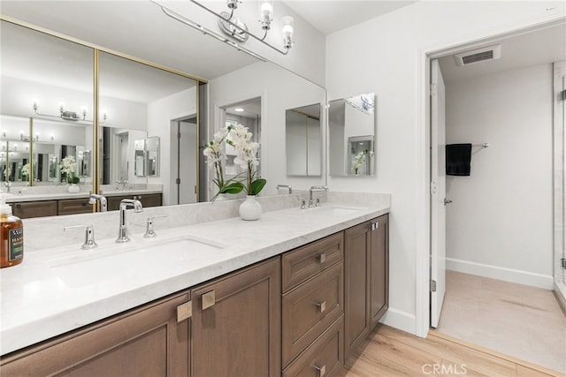 2392 Via Mariposa W Unit 3D, Laguna Woods, CA 92637 - full bath with double vanity, wood finished floors, and baseboards