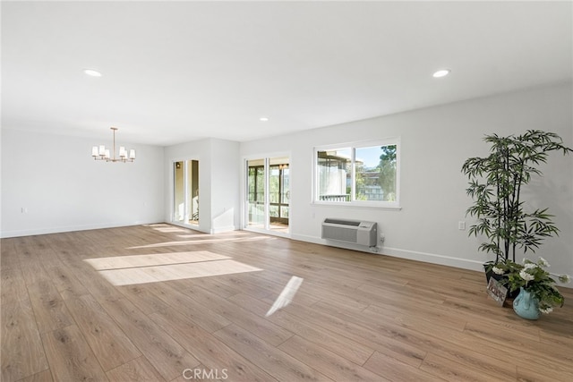 2392 Via Mariposa W Unit 3D, Laguna Woods, CA 92637 - unfurnished living room featuring a wall unit AC, a chandelier, light wood-type flooring, recessed lighting, and baseboards