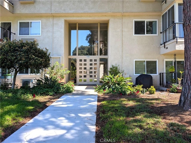 2392 Via Mariposa W Unit 3D, Laguna Woods, CA 92637 - view of exterior entry featuring stucco siding and oil tank