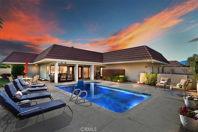 outdoor pool featuring fence, an outdoor living space, and a patio area