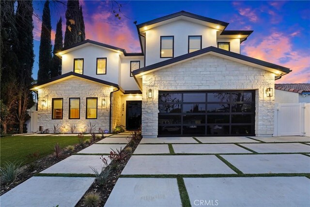 4949 Petit Ave, Encino, CA 91436 - view of front of property with a front lawn, driveway, a gate, stone siding, and a garage