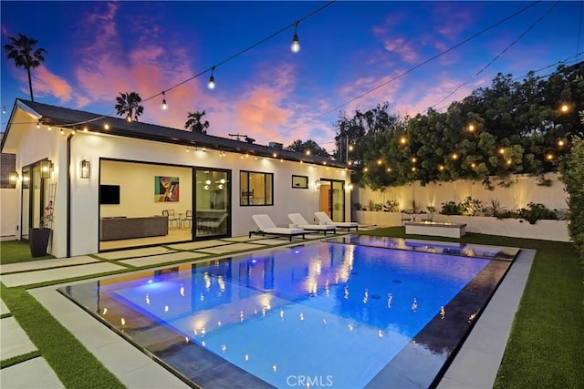 4949 Petit Ave, Encino, CA 91436 - pool at dusk with a patio area, a fenced in pool, an outdoor hangout area, and a fenced backyard