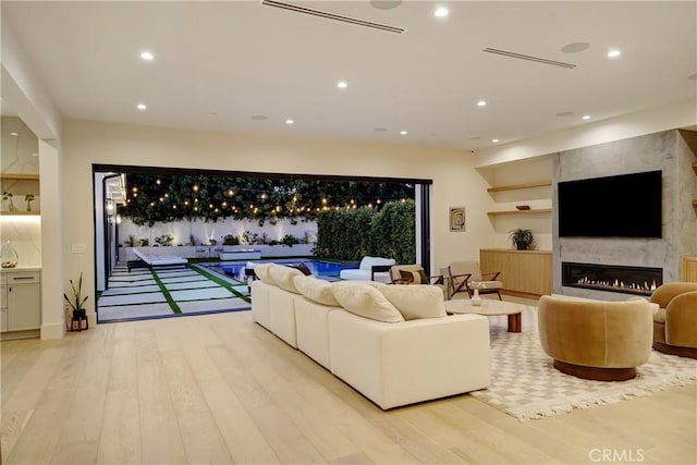 4949 Petit Ave, Encino, CA 91436 - living room featuring recessed lighting, a fireplace, and wood finished floors