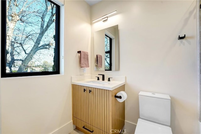 4949 Petit Ave, Encino, CA 91436 - bathroom with toilet, plenty of natural light, vanity, and baseboards
