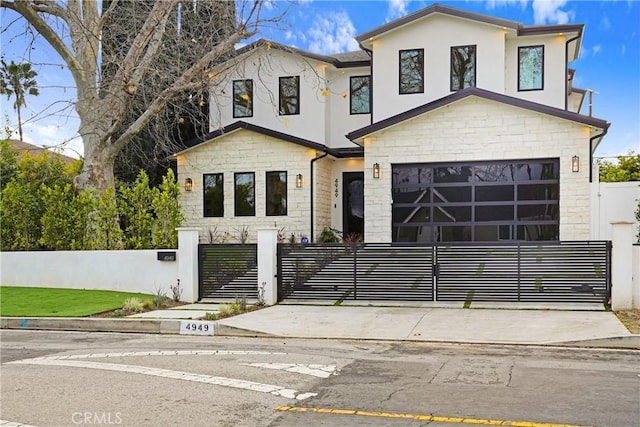 4949 Petit Ave, Encino, CA 91436 - modern home featuring a fenced front yard, stone siding, stucco siding, and a gate