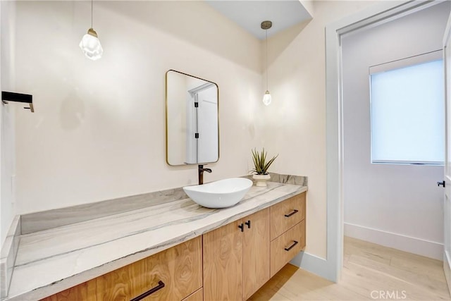 4949 Petit Ave, Encino, CA 91436 - bathroom featuring baseboards, wood finished floors, and vanity