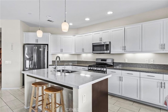 64132 Apache Mountain St, Desert Hot Springs, CA 92240 - kitchen featuring appliances with stainless steel finishes, a sink, white cabinets, light tile patterned floors, and recessed lighting