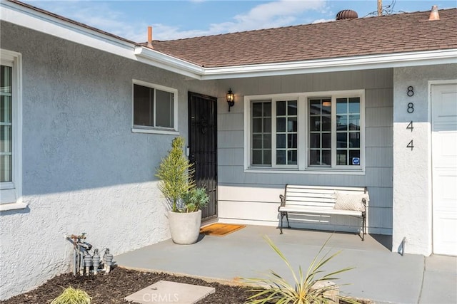 property entrance featuring stucco siding