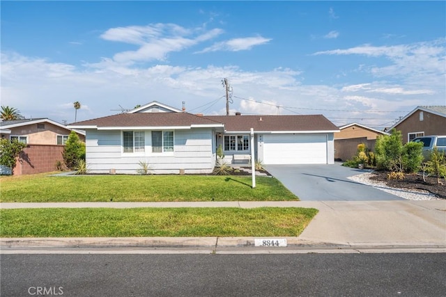 single story home with a front lawn, concrete driveway, and an attached garage