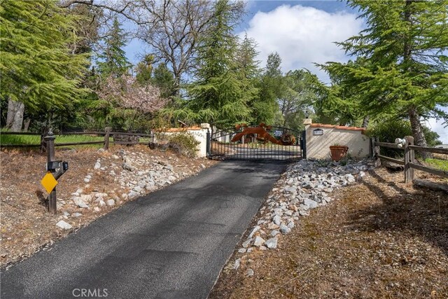 13155 San Antonio Rd, Atascadero, CA 93422 - view of asphalt driveway featuring a gate and view of wooded area