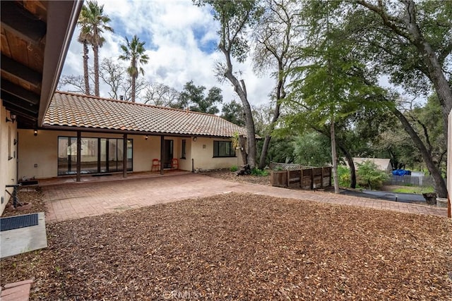 13155 San Antonio Rd, Atascadero, CA 93422 - rear view of house with a tile roof, stucco siding, and a patio